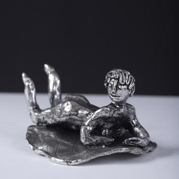 Silver plated bathers, silver, on her belly [1]