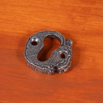 Key hole in patinated metal, silver, branche [1]
