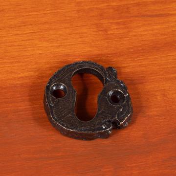 Key hole in patinated metal, bronze, branch [1]